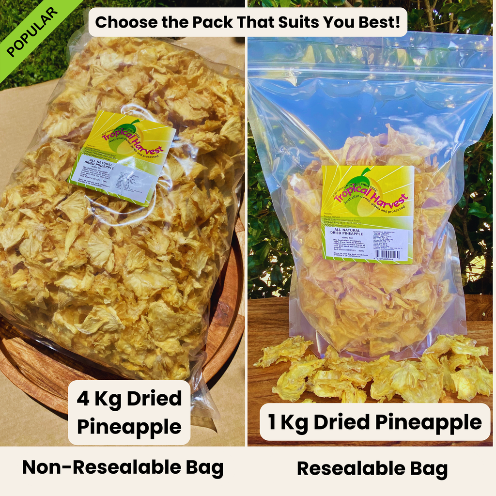 Side-by-side comparison of 4kg and 1kg Australian dried pineapple packs. The 4kg bulk pack is in a non-resealable bag, while the 1kg pack comes in a resealable bag. Both are 100% natural, additive-free, and grown in Australia. The 4kg bag is placed on a wooden tray, while the 1kg bag is displayed outdoors with fresh pineapple pieces