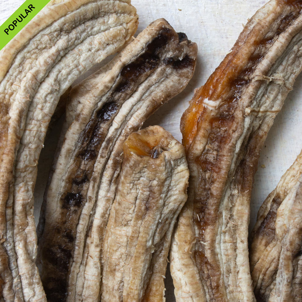 Close-up of whole dried bananas, showcasing their natural chewy texture and rich caramelized sweetness