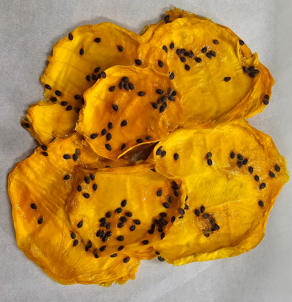 Dried Australian Mango with Passionfruit Pulp displayed on a white background, showing natural texture